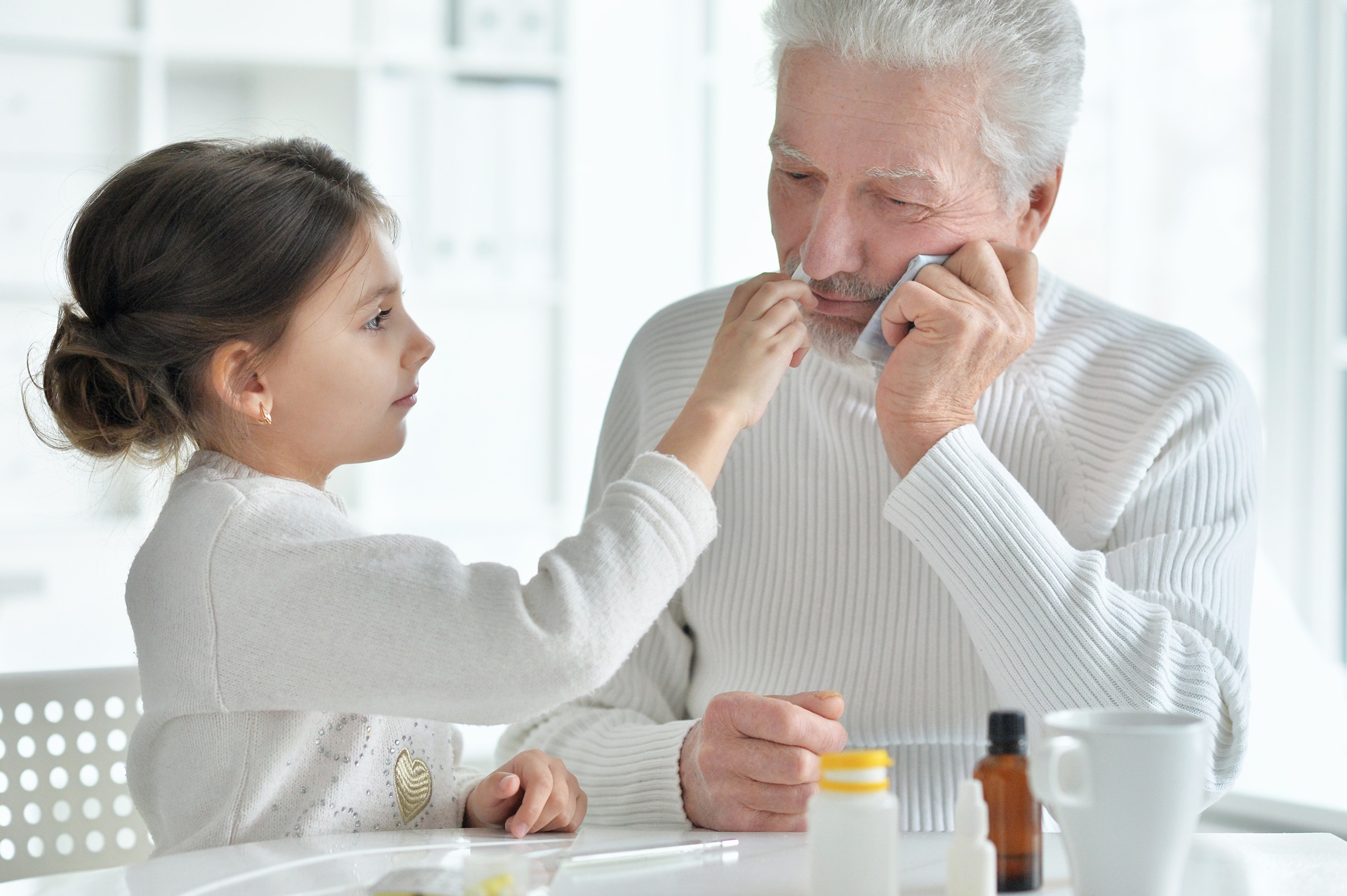 sick Granddaughter with grandfather sitting at home